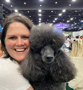 Happy Stylist With Poodle